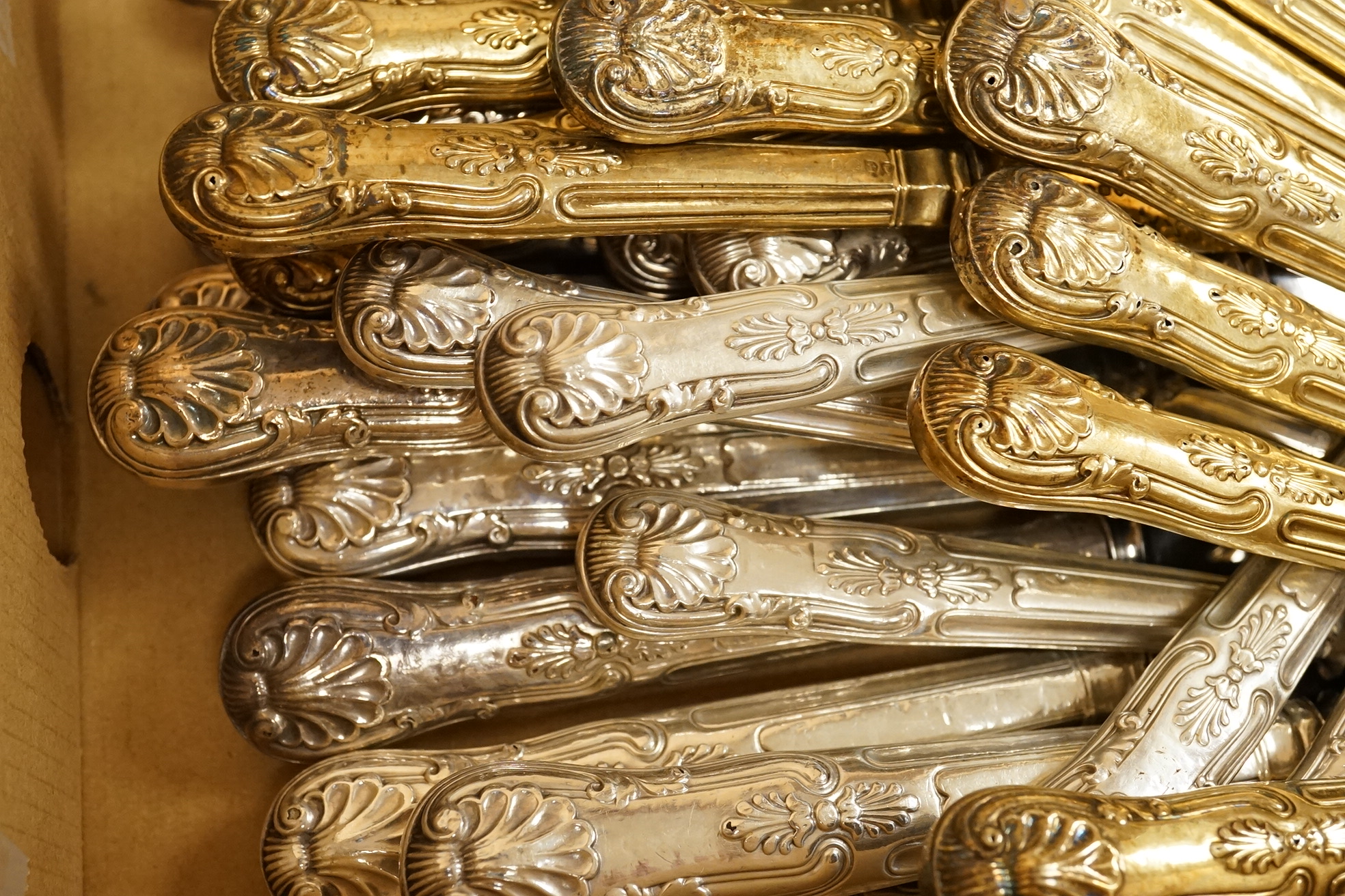 A set of eighteen William IV silver gilt King's pattern dessert knives, William Eaton, London, 1831/2, loaded handles, together with a set of twelve silver handled Kings pattern table knives and twelve matching dessert k